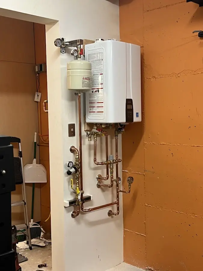 Plumbing technician inspecting water heater connections in Yakima